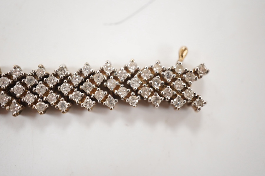 A modern 9ct gold and diamond cluster set bracelet, with arrow shaped links, 19.5cm, gross weight 25.2 grams. Condition - fair to good